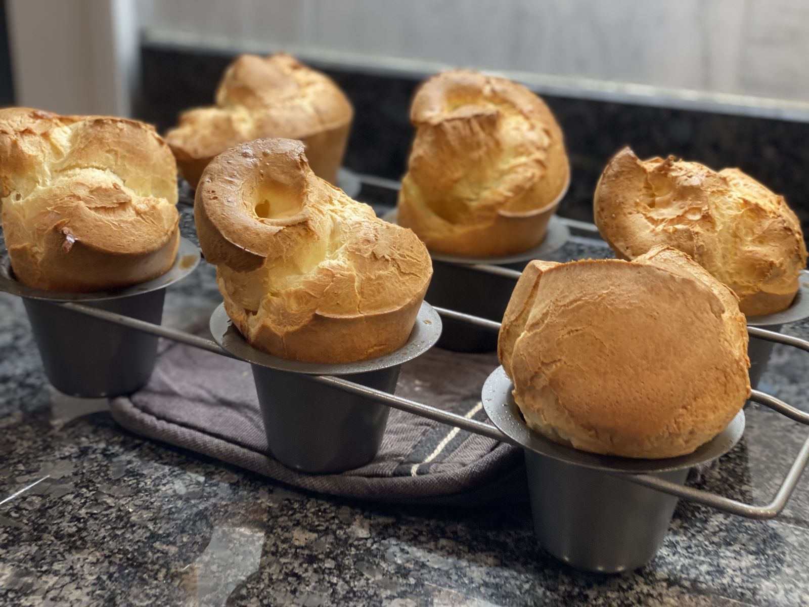 Tall golden popovers with optional savory herbs and Parmesan.