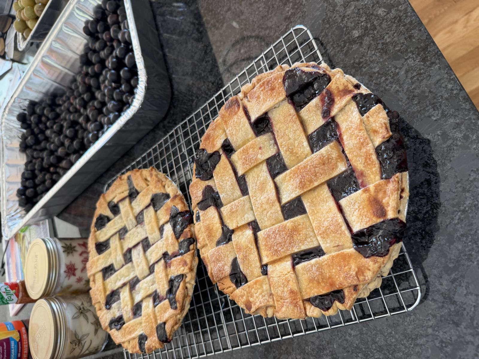 Jar of deep purple muscadine pie filling with spoonful shown.