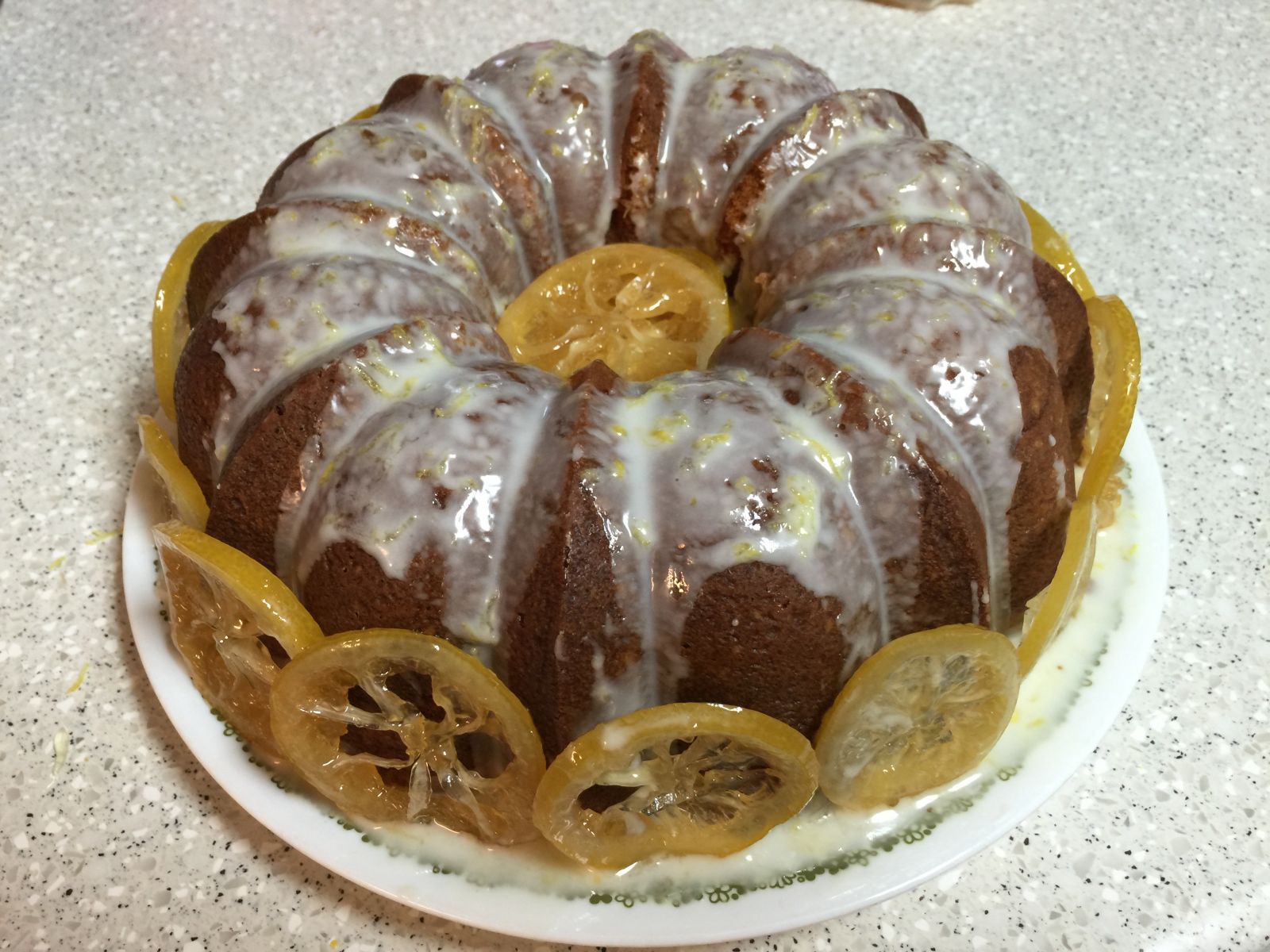 A glazed lemon-lime Bundt cake with citrus slices.