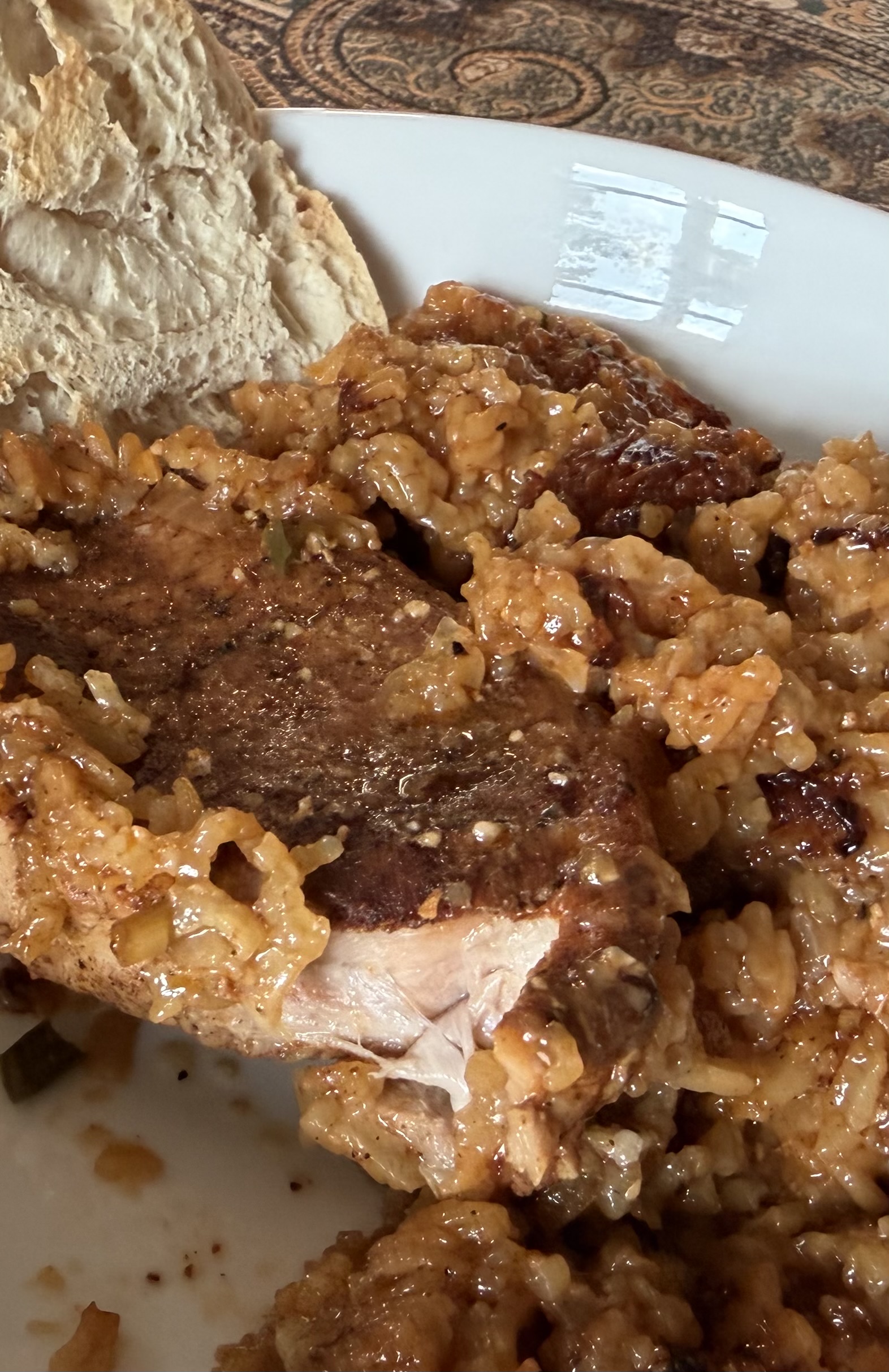 Slow-baked pork chops with rice, lemongrass, and lime wedges