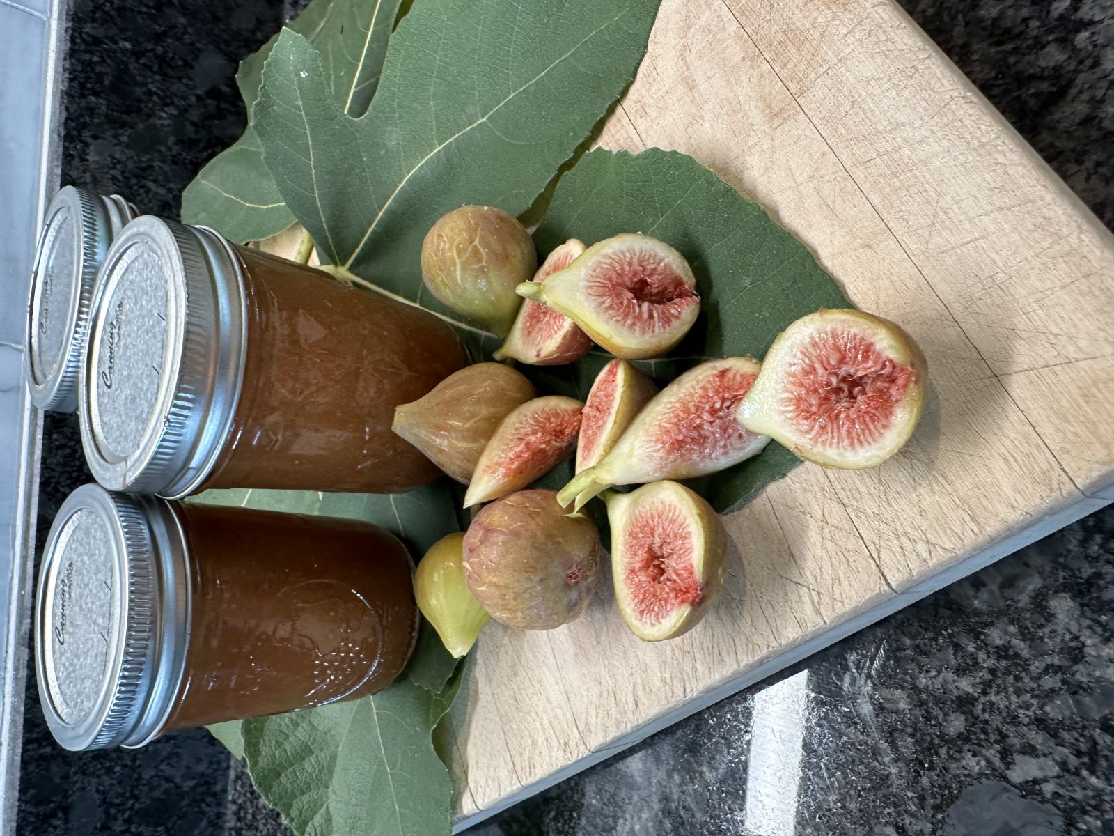 Homemade fresh fig jam in glass jars.