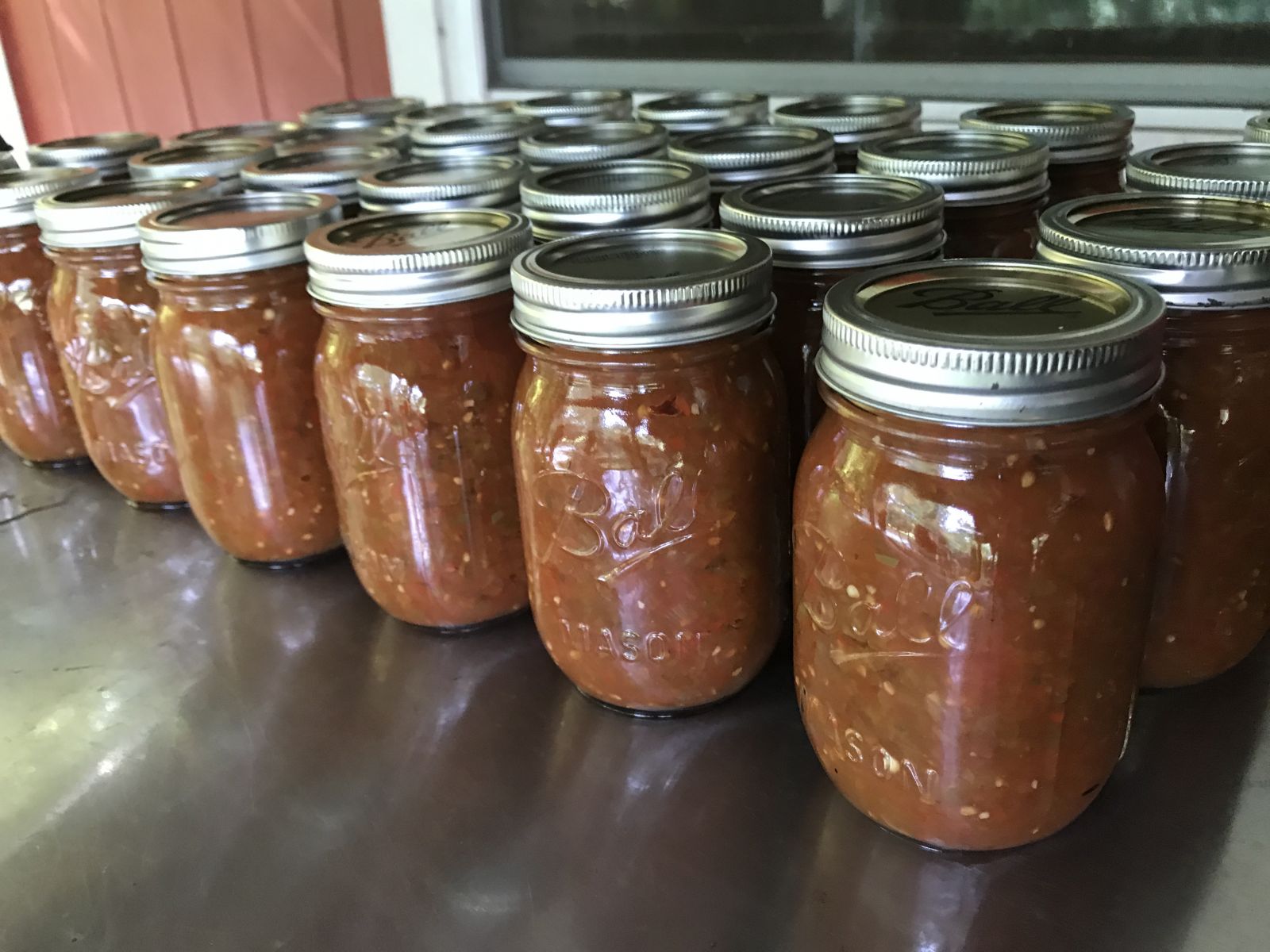 Canned jars of homemade summer garden salsa.