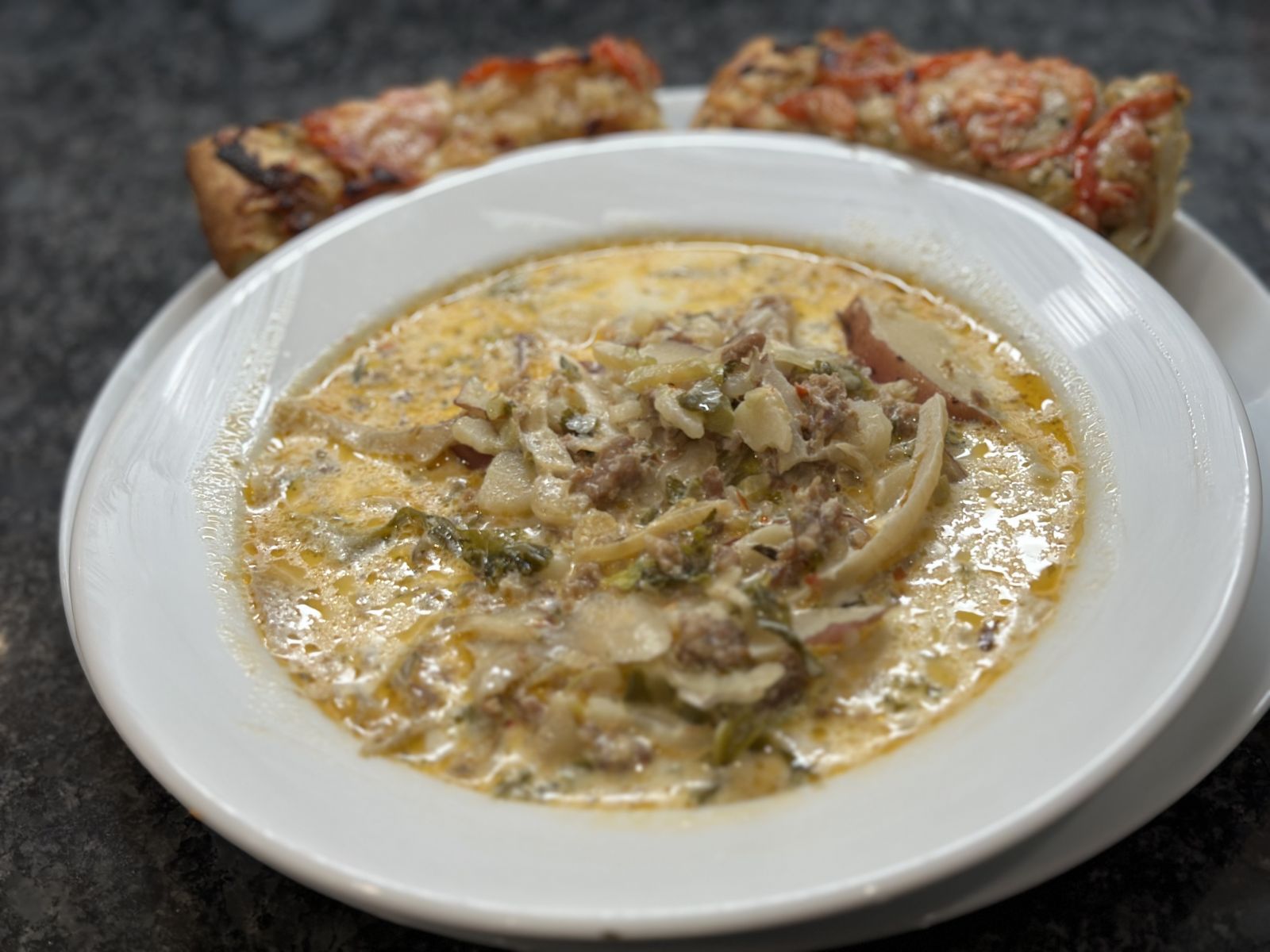 A hearty bowl of kale, sausage, and potato soup.